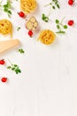 Ingredients for cooking pasta - tagliatelle, tomato, garlic, basil, parmesan cheese Royalty Free Stock Photo