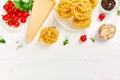 Ingredients for cooking pasta - tagliatelle, tomato, garlic, basil, parmesan cheese Royalty Free Stock Photo