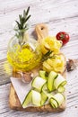Ingredients for cooking pasta with vegetables - spaghetti, zucchini, tomatoes, garlic, rosemary, pepper