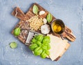 Ingredients for cooking Pesto sauce. Parmesan cheese, metal grater, fresh basil, olive oil, garlic and pine nuts on old Royalty Free Stock Photo