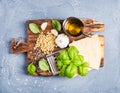 Ingredients for cooking Pesto sauce. Parmesan cheese, metal grater, fresh basil, olive oil, garlic and pine nuts on old Royalty Free Stock Photo