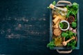 Ingredients for cooking Pesto sauce in a wooden box. Basil, parmesan cheese, olive oil, pine nuts, pepper, garlic. Royalty Free Stock Photo