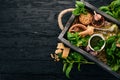 Ingredients for cooking Pesto sauce in a wooden box. Basil, parmesan cheese, olive oil, pine nuts, pepper, garlic. Royalty Free Stock Photo