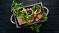 Ingredients for cooking Pesto sauce in a wooden box. Basil, parmesan cheese, olive oil, pine nuts, pepper, garlic. Royalty Free Stock Photo