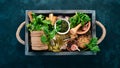 Ingredients for cooking Pesto sauce in a wooden box. Basil, parmesan cheese, olive oil, pine nuts, pepper, garlic. Royalty Free Stock Photo