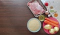 Ingredients for cooking pilaf with pork. Raw pork tenderloin, basmati rice, onions, caraway seeds, seasoning, tomato Royalty Free Stock Photo