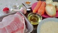 Ingredients for cooking pilaf with pork. Raw pork tenderloin, basmati rice, onions, caraway seeds, seasoning, tomato Royalty Free Stock Photo