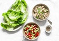 Ingredients for cooking - romaine salad and tuna, egg, tomato, avocado salad on a light background, top view. Delicious appetizer Royalty Free Stock Photo