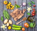 Ingredients for cooking on rustic wooden table around empty cutt Royalty Free Stock Photo