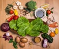 Ingredients for cooking on rustic wooden table around empty plat Royalty Free Stock Photo