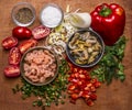 Ingredients for cooking seafood shrimp and mussels cherry tomatoes seasoning salt chopped red pepper chopped onion parsley on wood Royalty Free Stock Photo