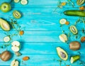 Ingredients for cooking smoothie. Organic green vegetables and fruits on wooden blue rustic background. Copy space, flat Royalty Free Stock Photo