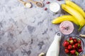 A large glass of strawberry-banana smoothie with ingredients Royalty Free Stock Photo