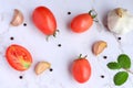 Ingredients for cooking, tomatoes, garlic, black pepper, and mint leaves on the table. Royalty Free Stock Photo