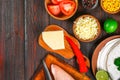 Ingredients for cooking traditional Mexican enchiladas. Tomatoes, cilantro, red onion, chicken fillet, tortillas, kukurznye flat c Royalty Free Stock Photo