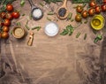 Ingredients for cooking vegetarian food cherry tomatoes, spices, herbs, oil, colorful rice in wooden spoons border ,place for tex