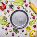 Ingredients for cooking vegetarian food, corn, radishes, rosemary, pepper, oil, seasonings, lined around pan place for text,fr Royalty Free Stock Photo