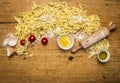 Ingredients for cooking vegetarian pasta with tomatoes, butter, eggs, rolling pin wooden rustic background top view close up Royalty Free Stock Photo