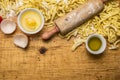 Ingredients for cooking vegetarian pasta tomatoes, butter, eggs, rolling pin on wooden rustic background top view close up bo Royalty Free Stock Photo