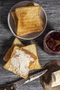 Ingredients for a delicious breakfast - toasted bread with butter and homemade raspberry jam on a wooden table Royalty Free Stock Photo