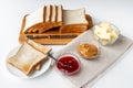 Ingredients for a delicious breakfast - toasted bread, butter, peanut butter and homemade raspberry jam on a table Royalty Free Stock Photo