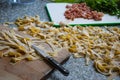 Ingredients for a delicious Italian dinner - homemade pasta, raw bacon and fresh green parsley Royalty Free Stock Photo