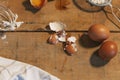 Ingredients for the dough: eggs and flour with a whisk on wooden background. Top view. Closed image