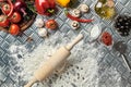 Ingredients and dough for making pizzas with an overhead view on freshly mixed mounds of pastry, a jar of olive oil and Royalty Free Stock Photo