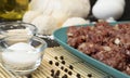 Ingredients for dumplings: dough balls and ground meat