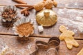 Ingredients and figurines for making ginger biscuits on a wooden table.