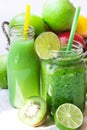 Ingredients for green fruit juice, glass jar mug with vegetable smoothie on wood table, outdoors Royalty Free Stock Photo