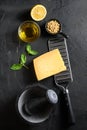 ingredients for green pesto over black stone background Parmesan cheese, basil leaves, pine nuts, olive oil, garlic mortar top Royalty Free Stock Photo