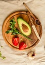 Ingredients for guacamole on a wooden board. Parsley, avocado, tomatoes, garlic, black pepper Royalty Free Stock Photo