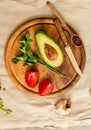 Ingredients for guacamole on a wooden board. Parsley, avocado, tomatoes, garlic, black pepper.Top view. Comfort food concept Royalty Free Stock Photo