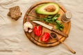 Ingredients for guacamole on a wooden board. Parsley, avocado, tomatoes, garlic, black pepper.Top view Royalty Free Stock Photo