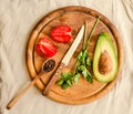 Ingredients for guacamole on a wooden board. Parsley, avocado, tomatoes, garlic, black pepper.Top view Royalty Free Stock Photo