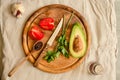 Ingredients for guacamole on a wooden board. Parsley, avocado, tomatoes, garlic, black pepper.Top view Royalty Free Stock Photo