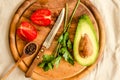 Ingredients for guacamole on a wooden board. Parsley, avocado, tomatoes, garlic, black pepper.Top view Royalty Free Stock Photo