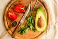 Ingredients for guacamole on a wooden board. Parsley, avocado, tomatoes, garlic, black pepper.Top view Royalty Free Stock Photo