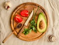 Ingredients for guacamole on a wooden board. Parsley, avocado, tomatoes, garlic, black pepper.Top view Royalty Free Stock Photo