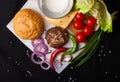 Ingredients for hamburger on a dark background. Top view. Royalty Free Stock Photo