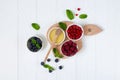 Ingredients for healthy breakfast - fresh rastberry, red currant, blueberry and honey top view on white wooden table. Organic Royalty Free Stock Photo