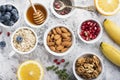 Ingredients for a healthy breakfast, nuts, oatmeal, honey, berries, fruits, blueberry, orange, pomegranate seeds