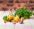 Ingredients for healthy Italian meal with spaghetti, tomatoes, basil, garlic, parsley, olive oil Royalty Free Stock Photo