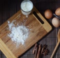 Ingredients for homemade bread or pasta. Eggs, milk, flour on a rustic surface top view. Backing background.