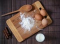Ingredients for homemade bread or pasta. Eggs, milk, flour on a rustic surface top view. Backing background.