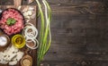 Ingredients for homemade burgers with onions and garlic, laid out on a chopping board with a green onions border ,place for text o