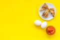 Ingredients for homemade cookies. Fresh cookies near jam, eggs on yellow background top view copy space Royalty Free Stock Photo