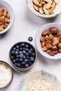 Ingredients for homemade granola: oatmeal, coconut crunch, pecans, almond, brazilan nuts, blueberries Royalty Free Stock Photo