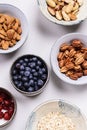 Ingredients for homemade granola: oatmeal, dried cherry, pecans, almond, brazilan nuts, blueberries in a bowls Royalty Free Stock Photo